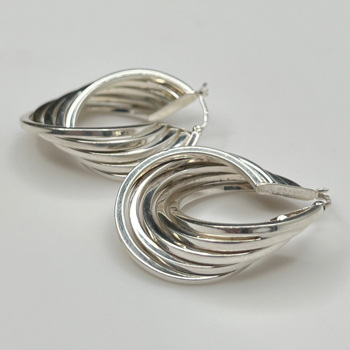 Side angle showing curved sterling hoop earring shape