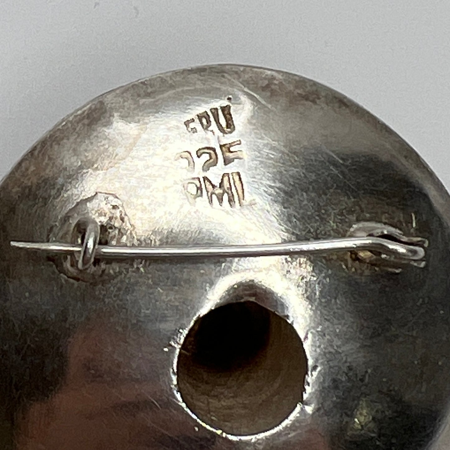 Close-up of brooch reverse stamped PERU 925 PML with C-clasp pin