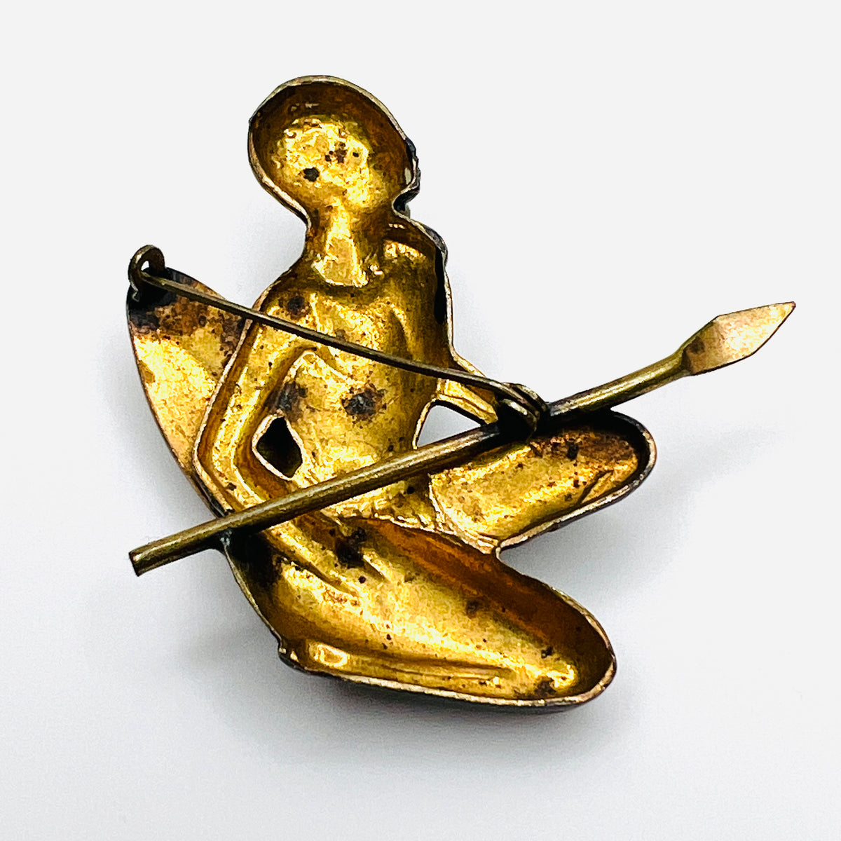 Reverse of vintage African hunter brooch showing gold-tone cast-metal construction and C-clasp fastening.