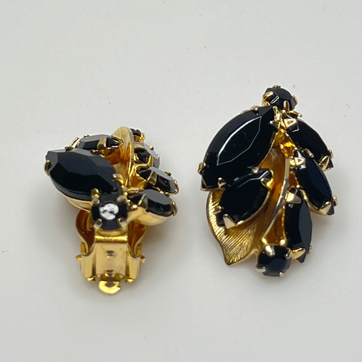 Vintage black rhinestone and gold-tone leaf brooch with matching clip-on earrings