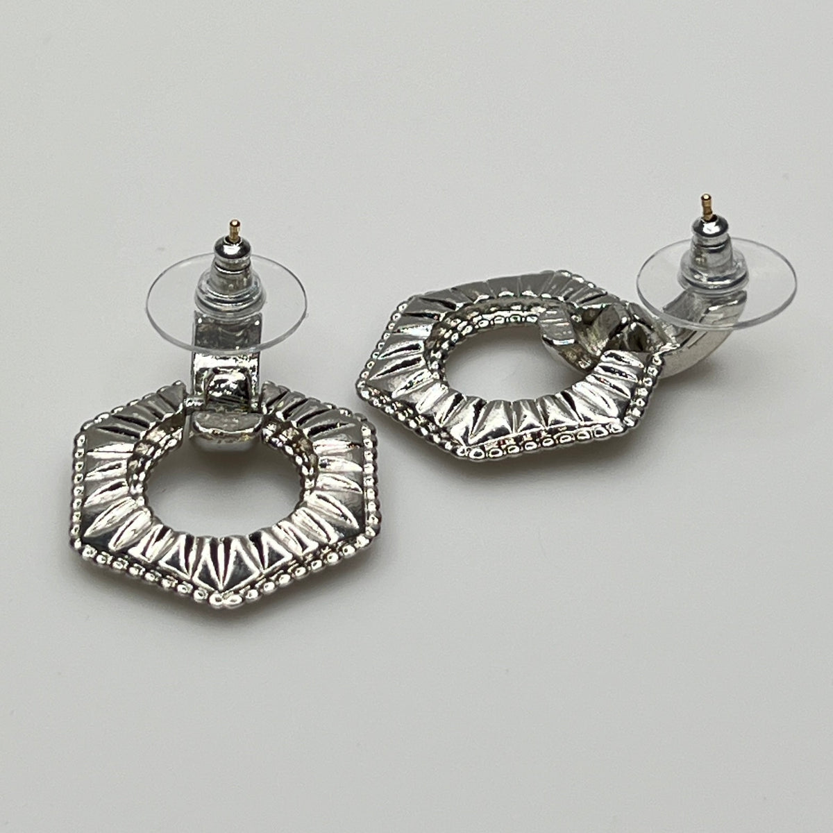Close-up of earrings showing silver finish and 14K gold post with stabilizer backs