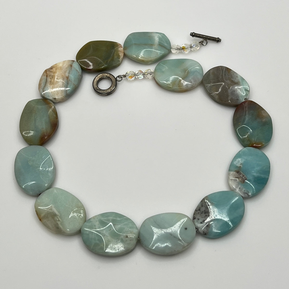 Close-up of pale blue-green amazonite beads with natural marbling