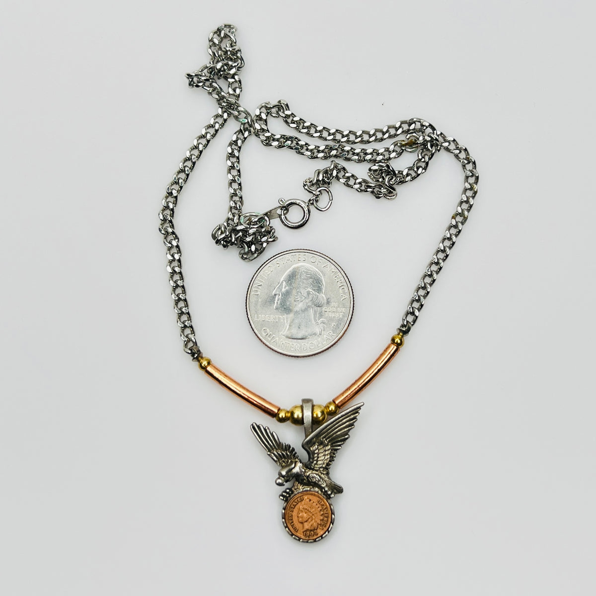 Full necklace with eagle coin pendant and chain, size reference with quarter