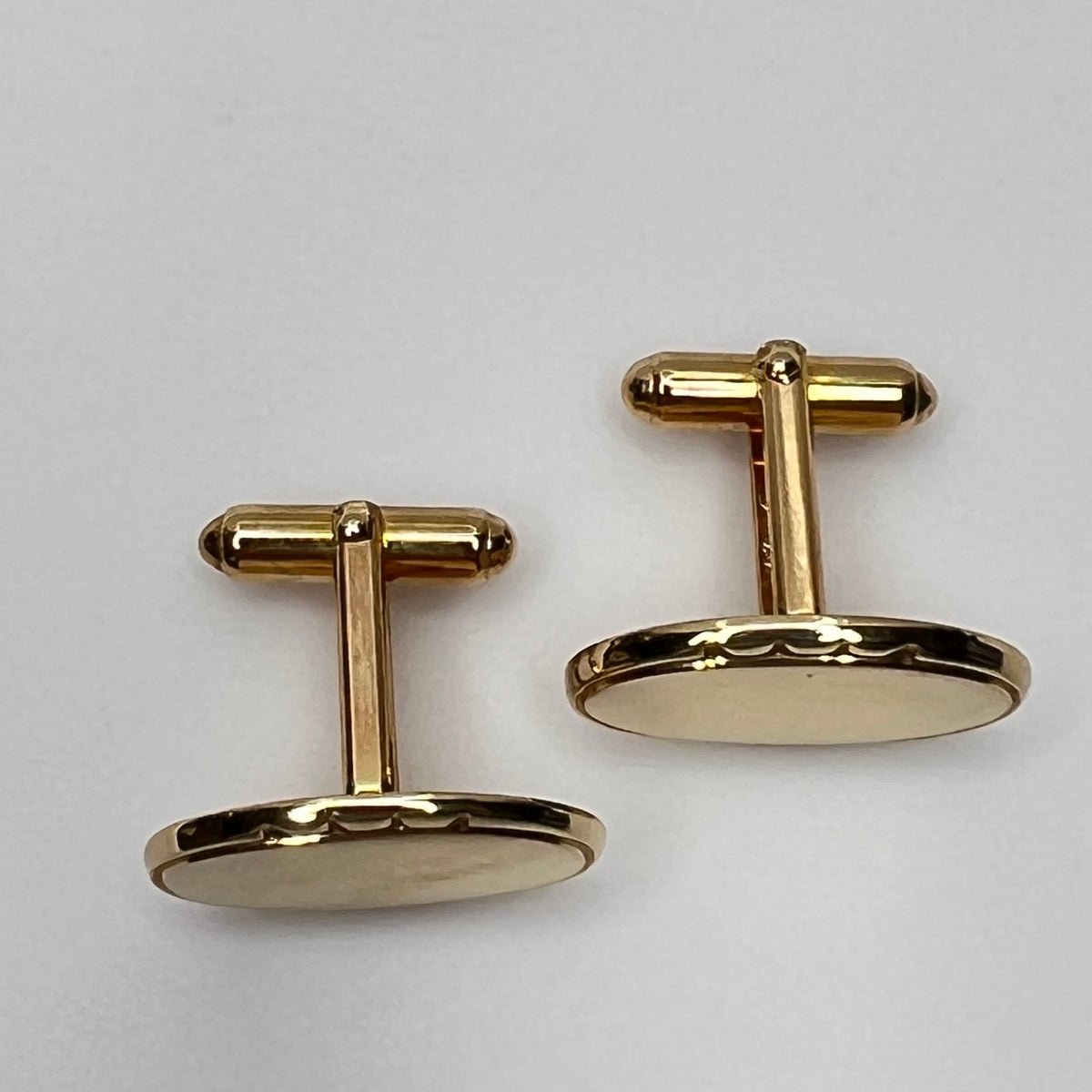 Vintage Anson gold-tone oval cufflinks with faceted edge detail