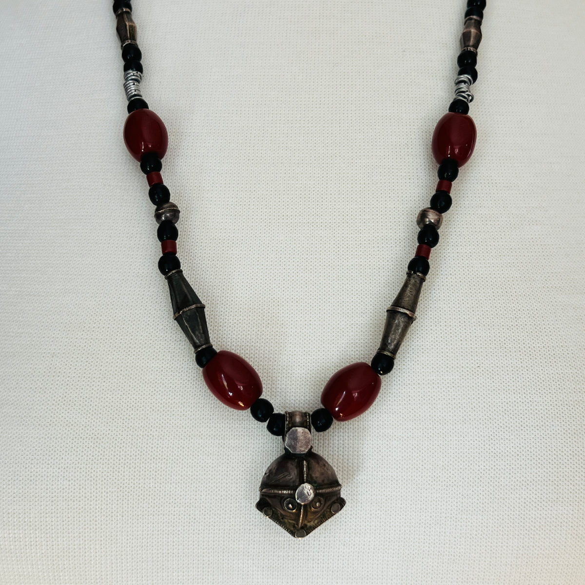 Vintage ethnic-inspired red ceramic and black glass bead necklace with matching earrings and silver-tone pendant