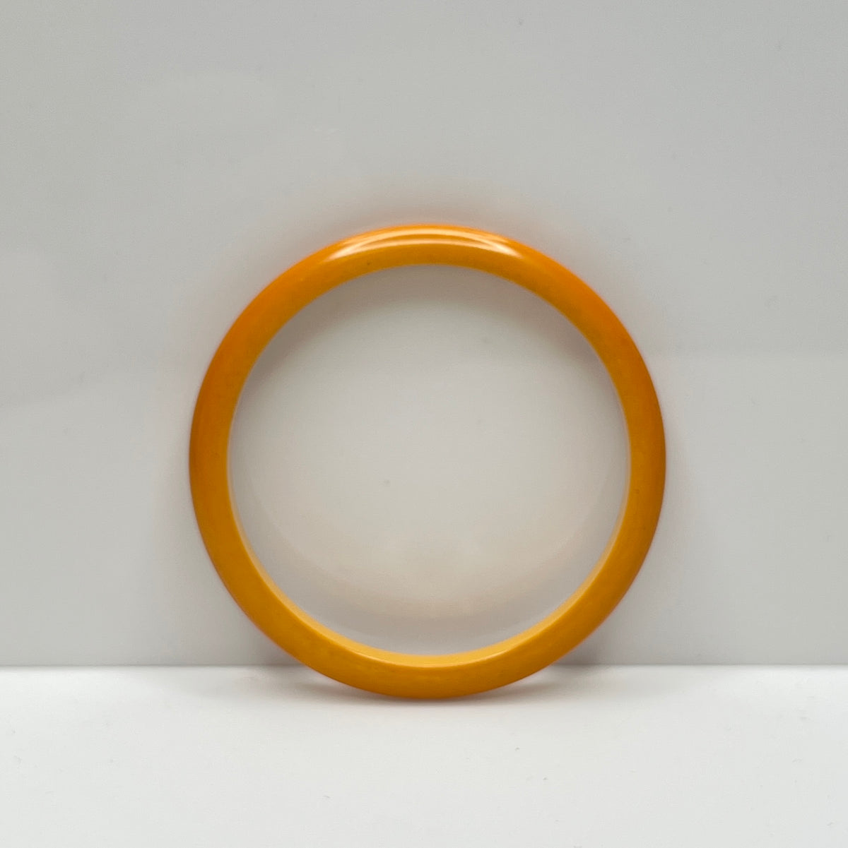 Smooth round Bakelite bangle in warm butterscotch color, size 8 fit