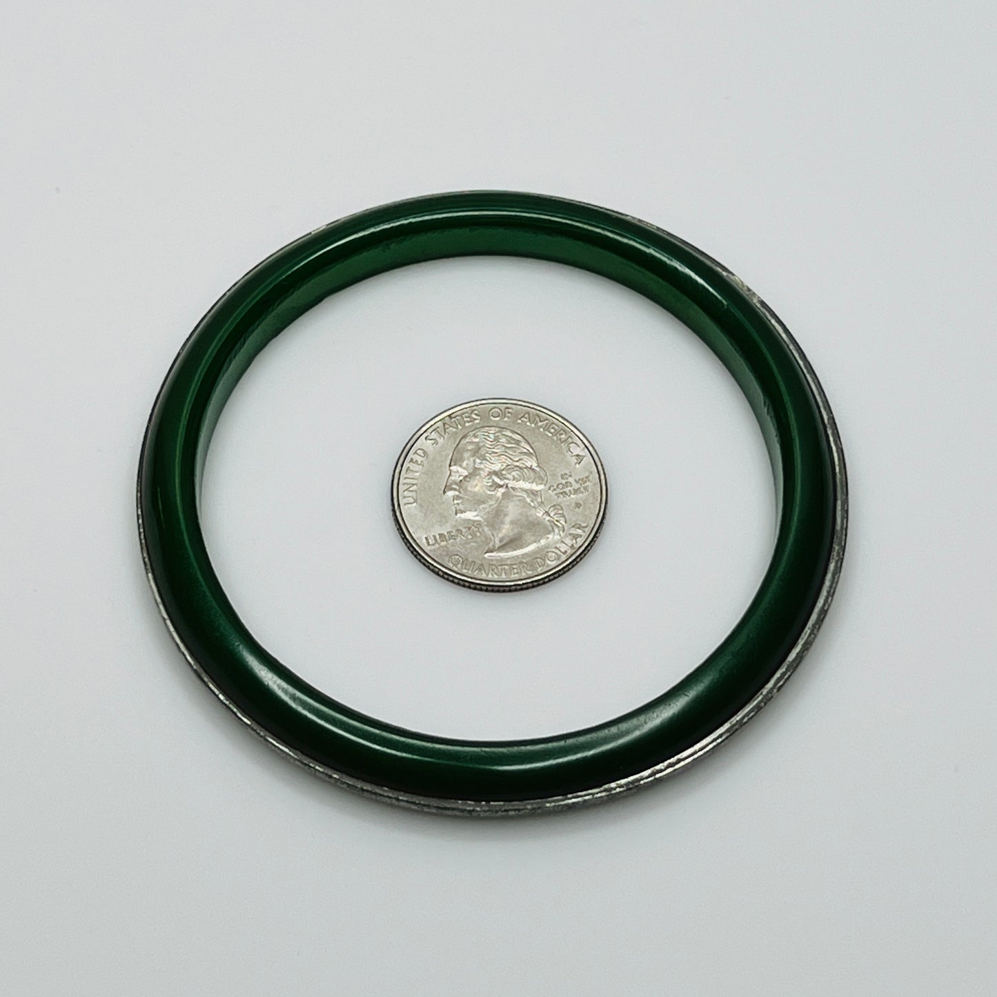 Round Bakelite bangle with inset silver-tone detail, flat lay