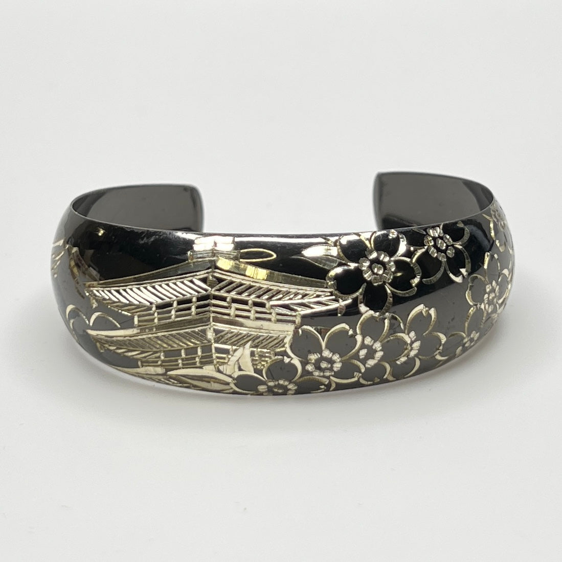 Blackened sterling cuff bracelet with Japanese temple and floral design