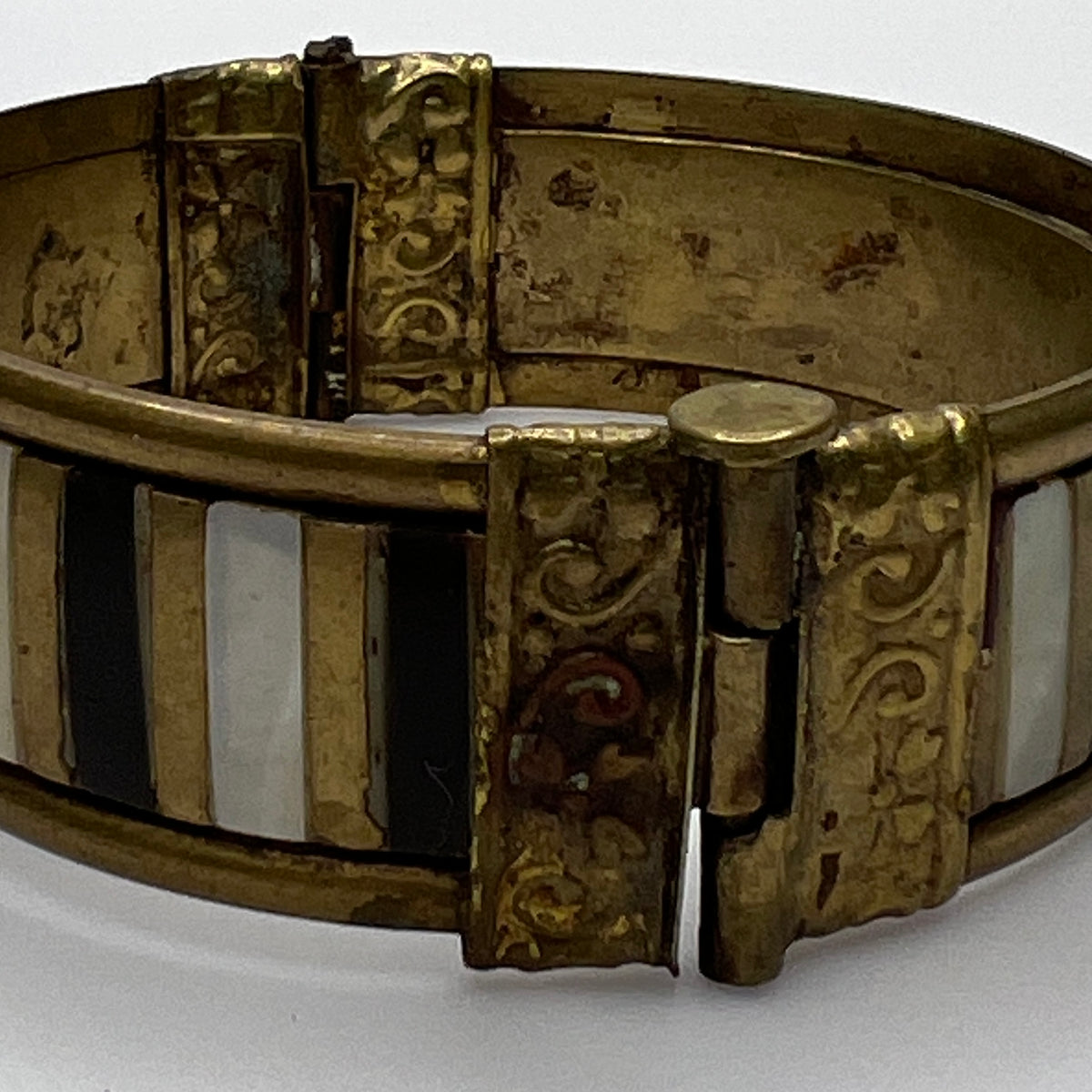 Vintage bangle with pin closure and etched end caps, close-up view