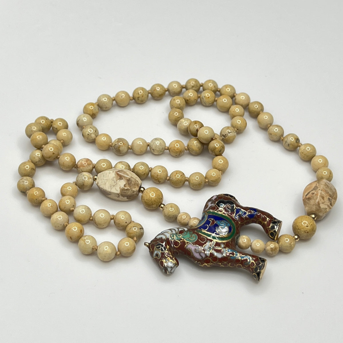 Hand-knotted beige stone bead strand with asymmetrical design