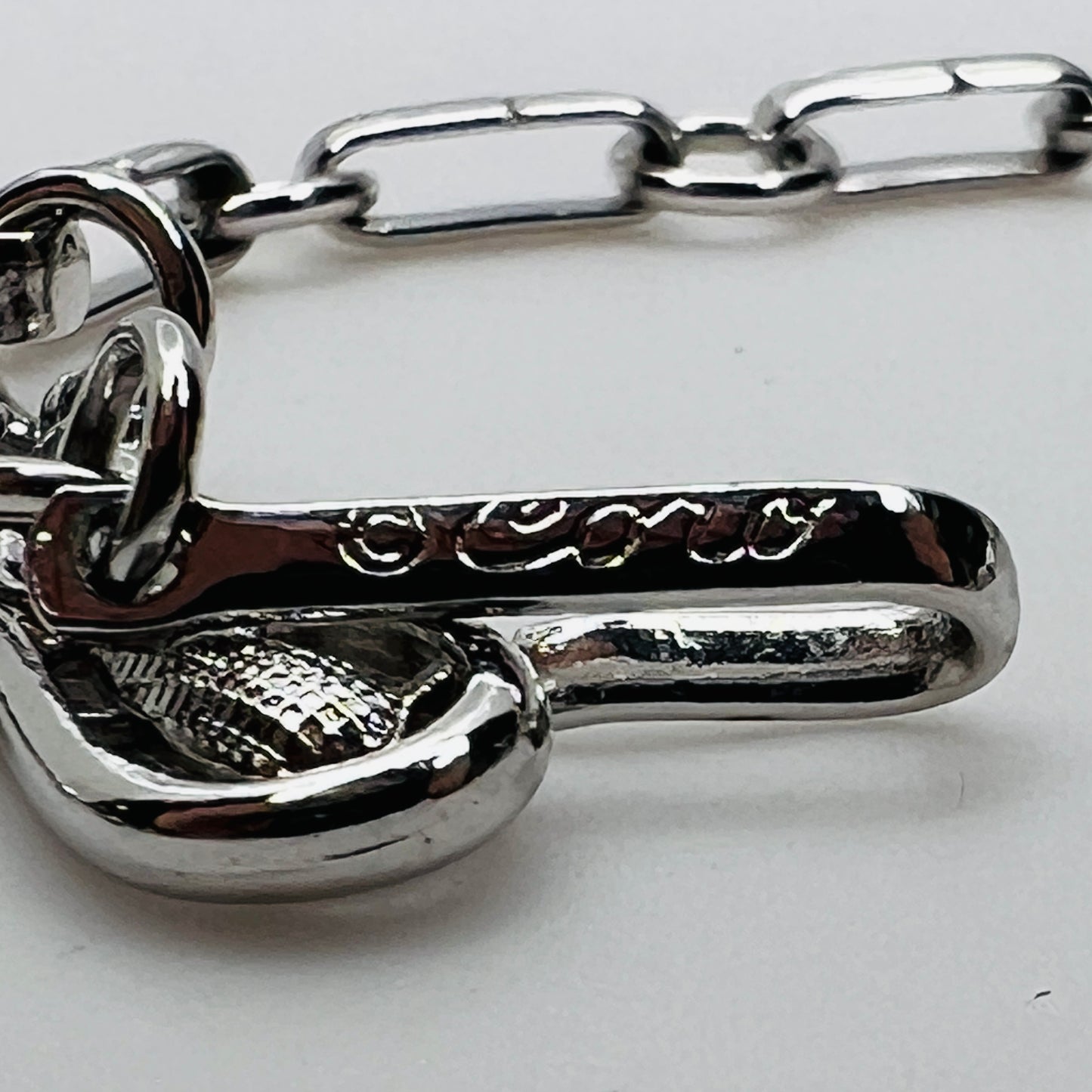 Close-up of signed Coro hook clasp on vintage choker necklace