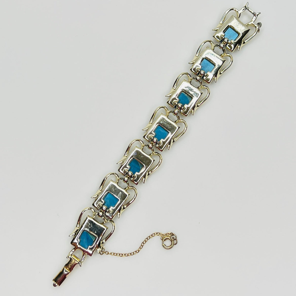 Vintage Coro bracelet with marbled blue thermoset cabochons, laid flat