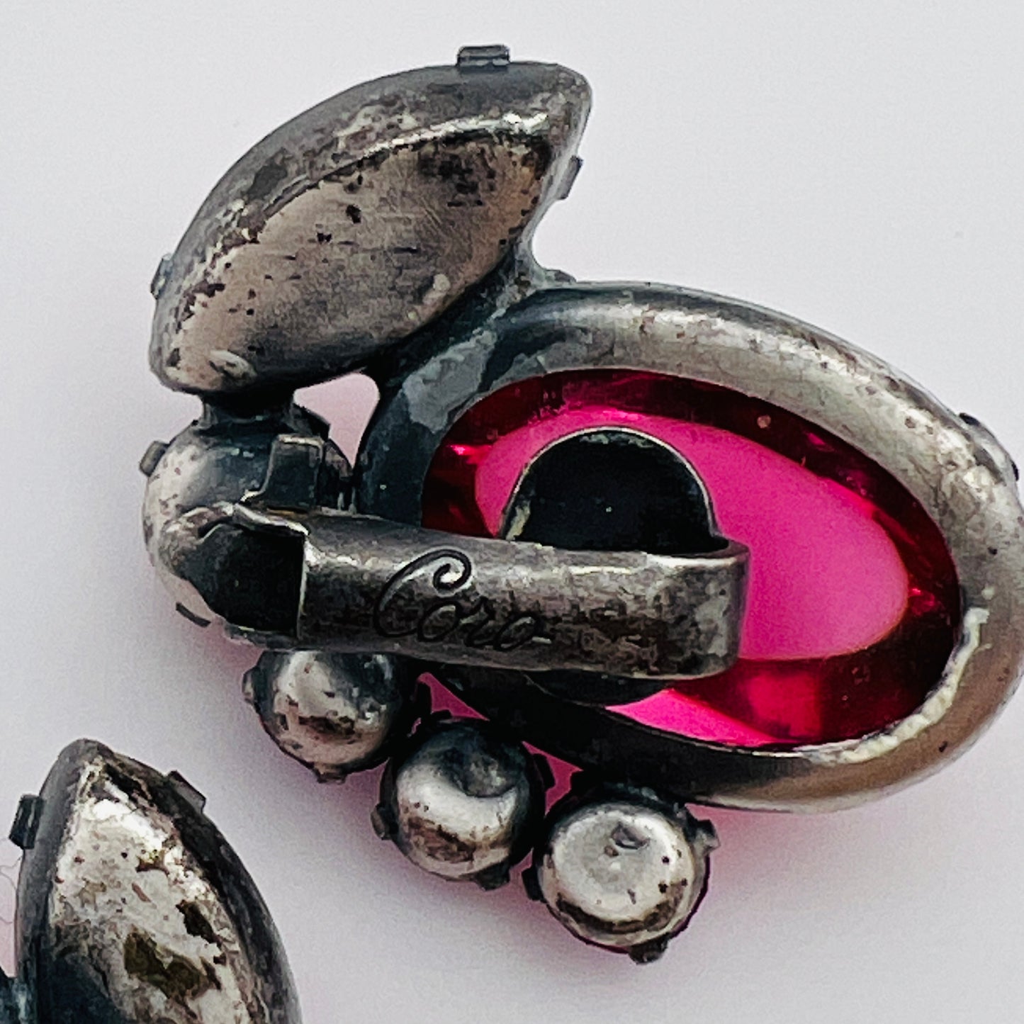 Close-up of signed Coro earrings with prong-set rhinestones