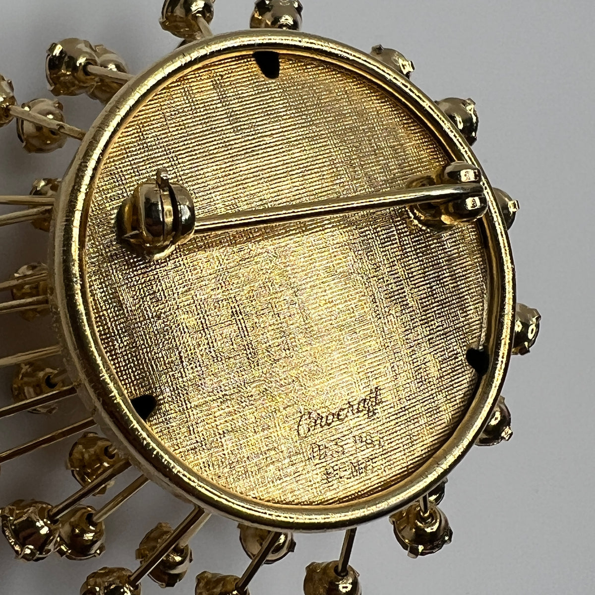 Close-up of signed back of vintage Corocraft Sputnik brooch