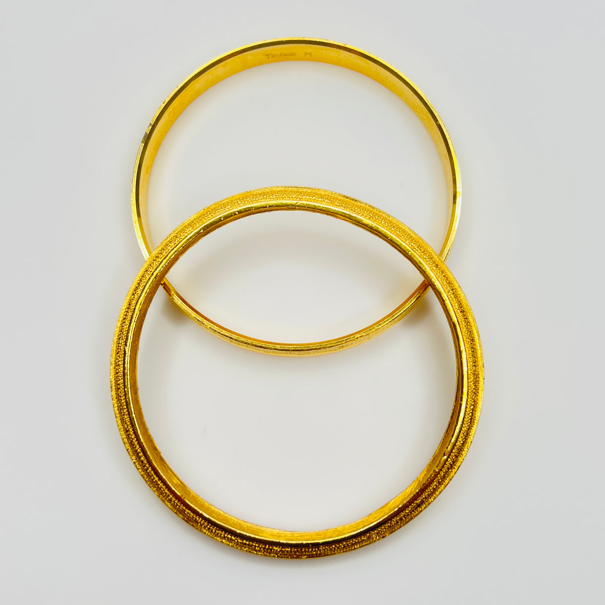Crown Trifari gold tone etched bangle set 1970s