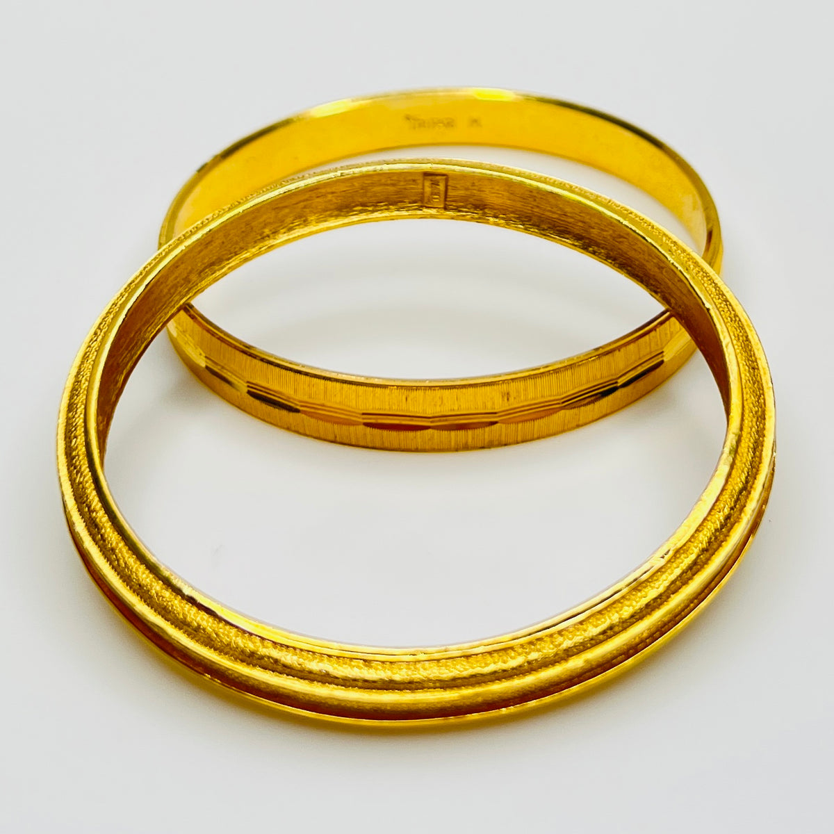 Signed Crown Trifari textured gold bangles interior stamp