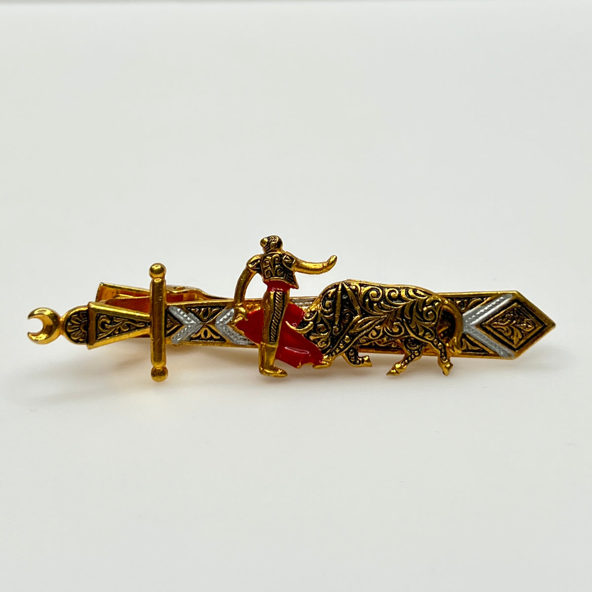 1990s Damascene matador and bull tie clip with gold and black enamel