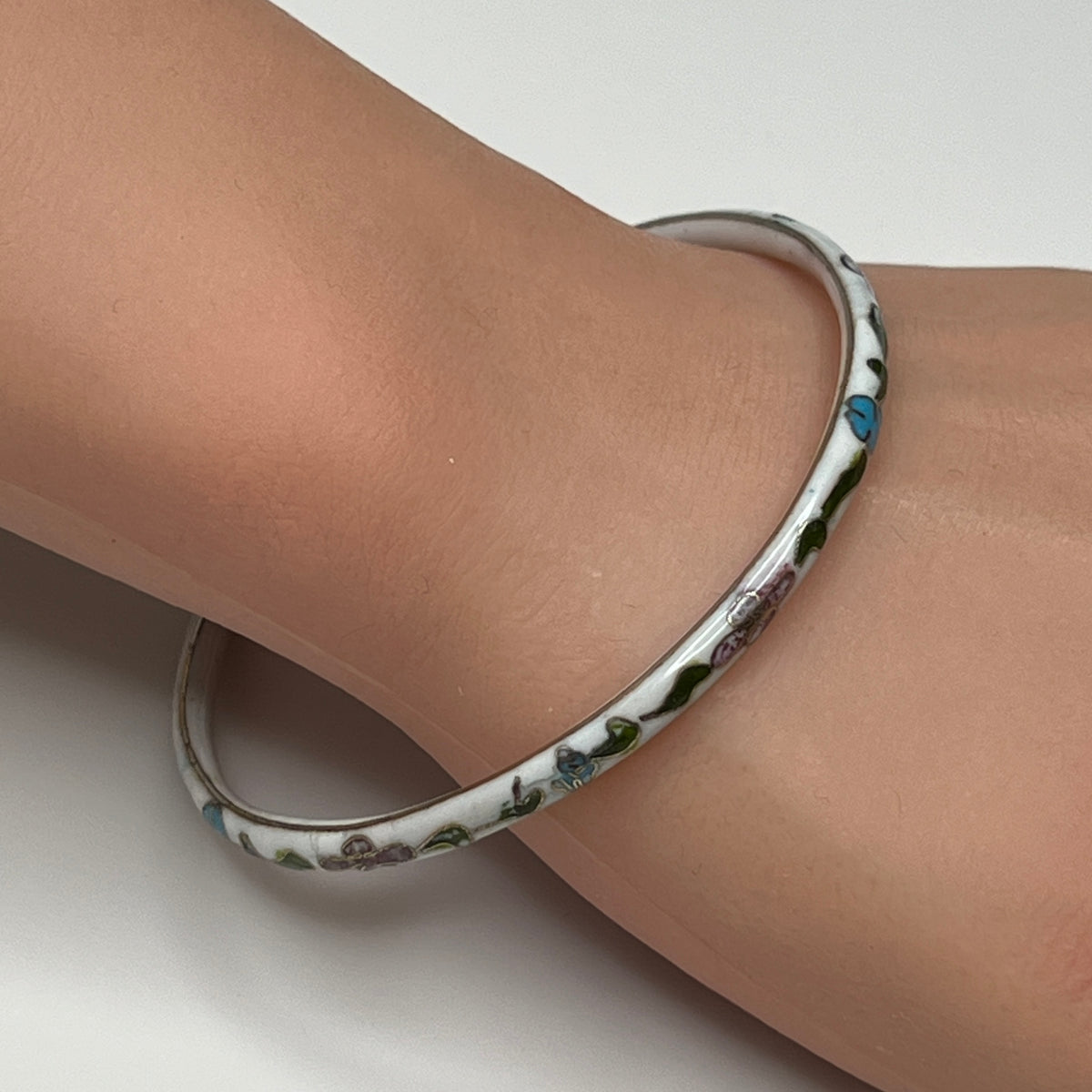 Skinny 1970s enamel bracelet in boho style on wrist