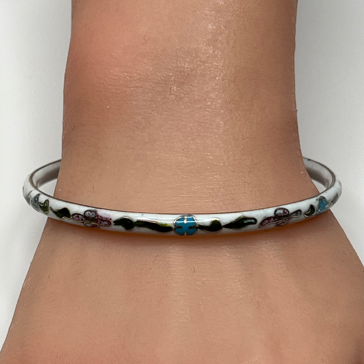 Skinny 1970s enamel bracelet in boho style on wrist