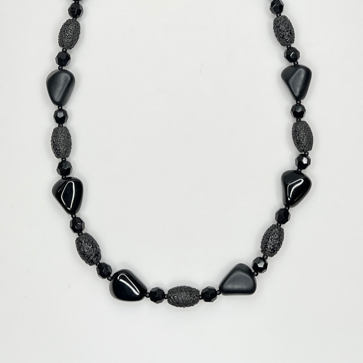 Geometric black glass bead necklace with textured and glossy finishes