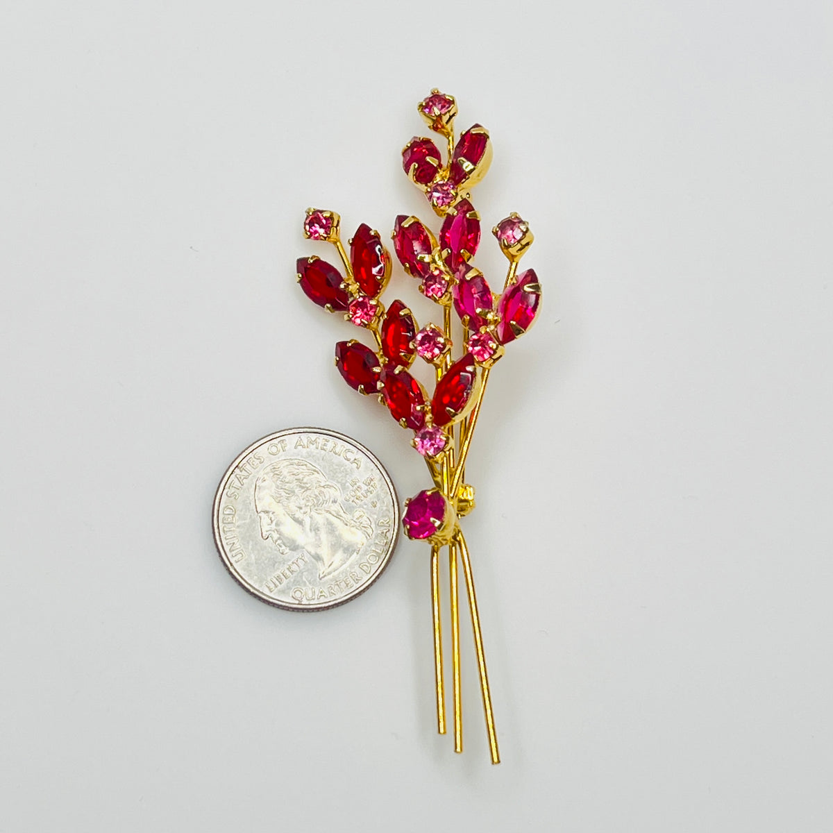Close-up of unsigned Juliana brooch with prong-set glass rhinestones and layered structure