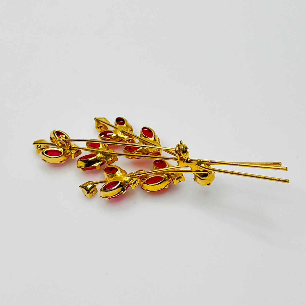 Close-up of unsigned Juliana brooch with prong-set glass rhinestones and layered structure