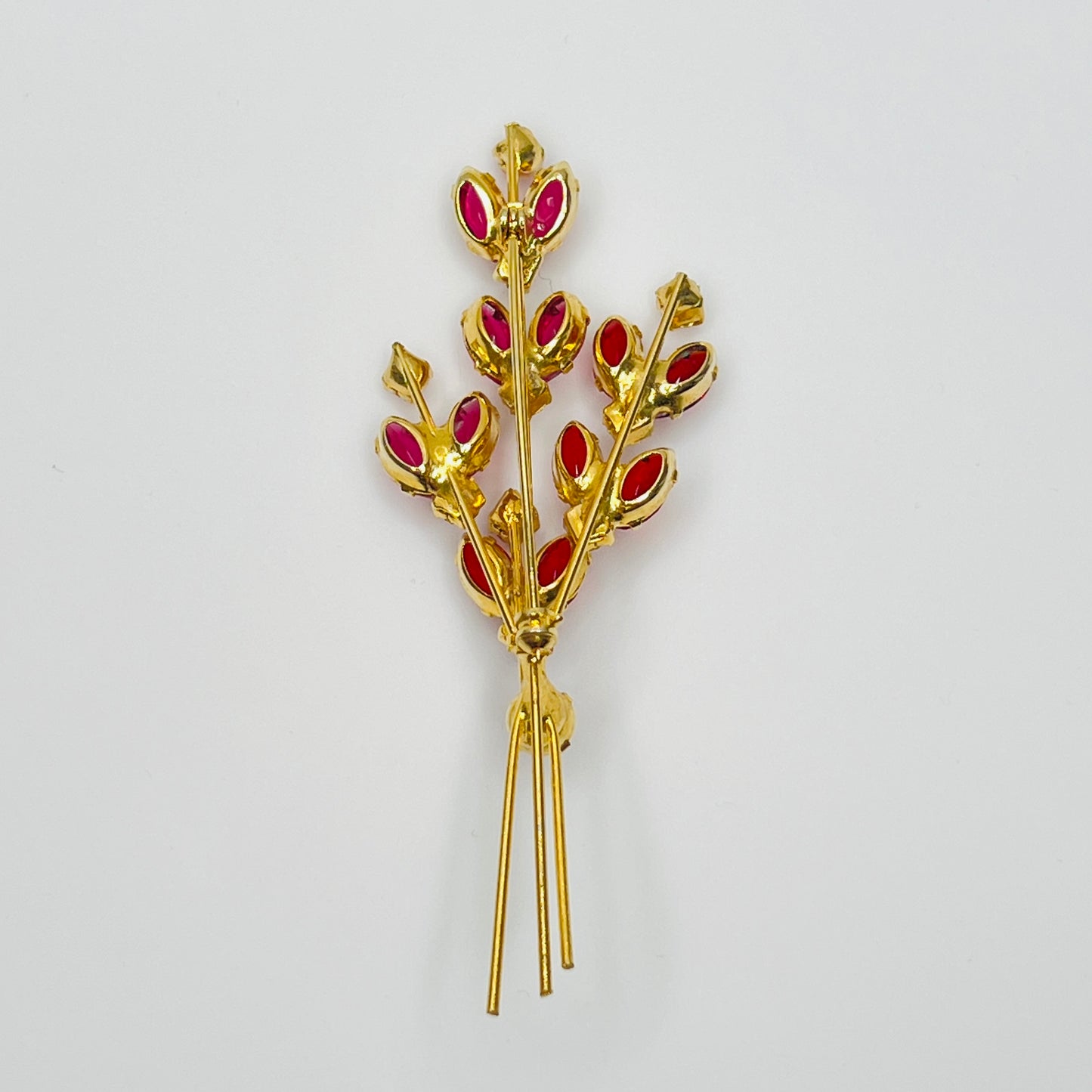 Close-up of unsigned Juliana brooch with prong-set glass rhinestones and layered structure
