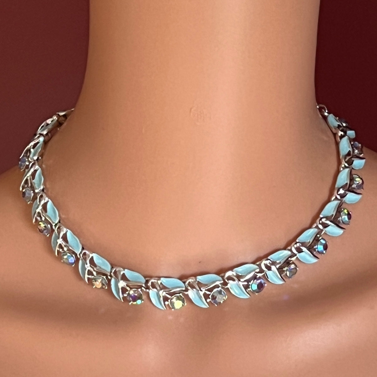 Blue enamel and rhinestone choker necklace modeled on neck