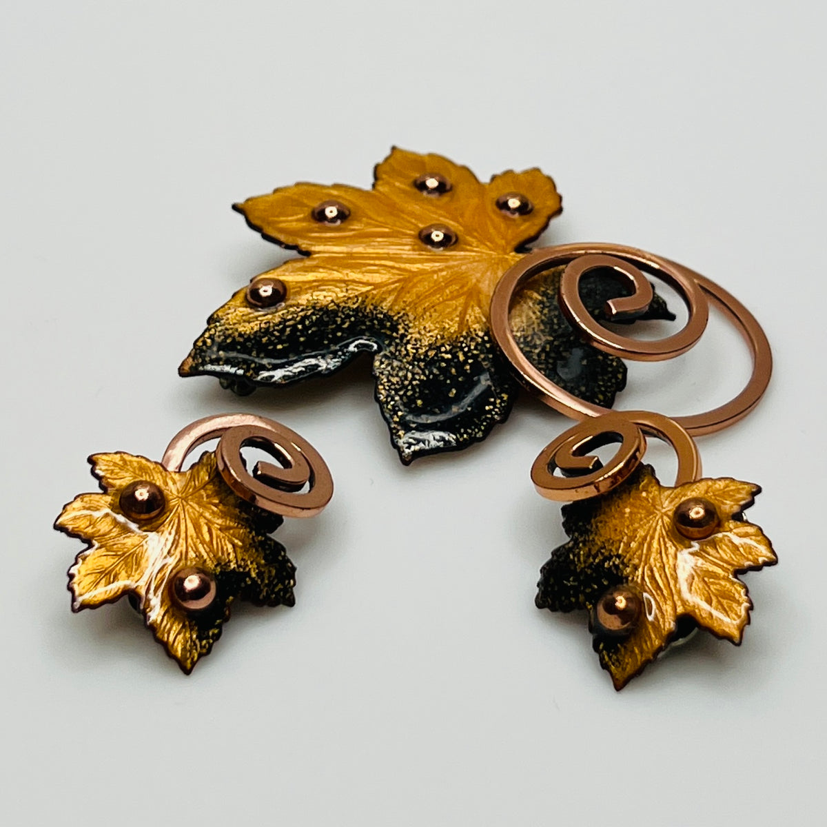 Matisse copper enamel maple leaf brooch and clip-on earring set in gold and black, signed mid-century vintage