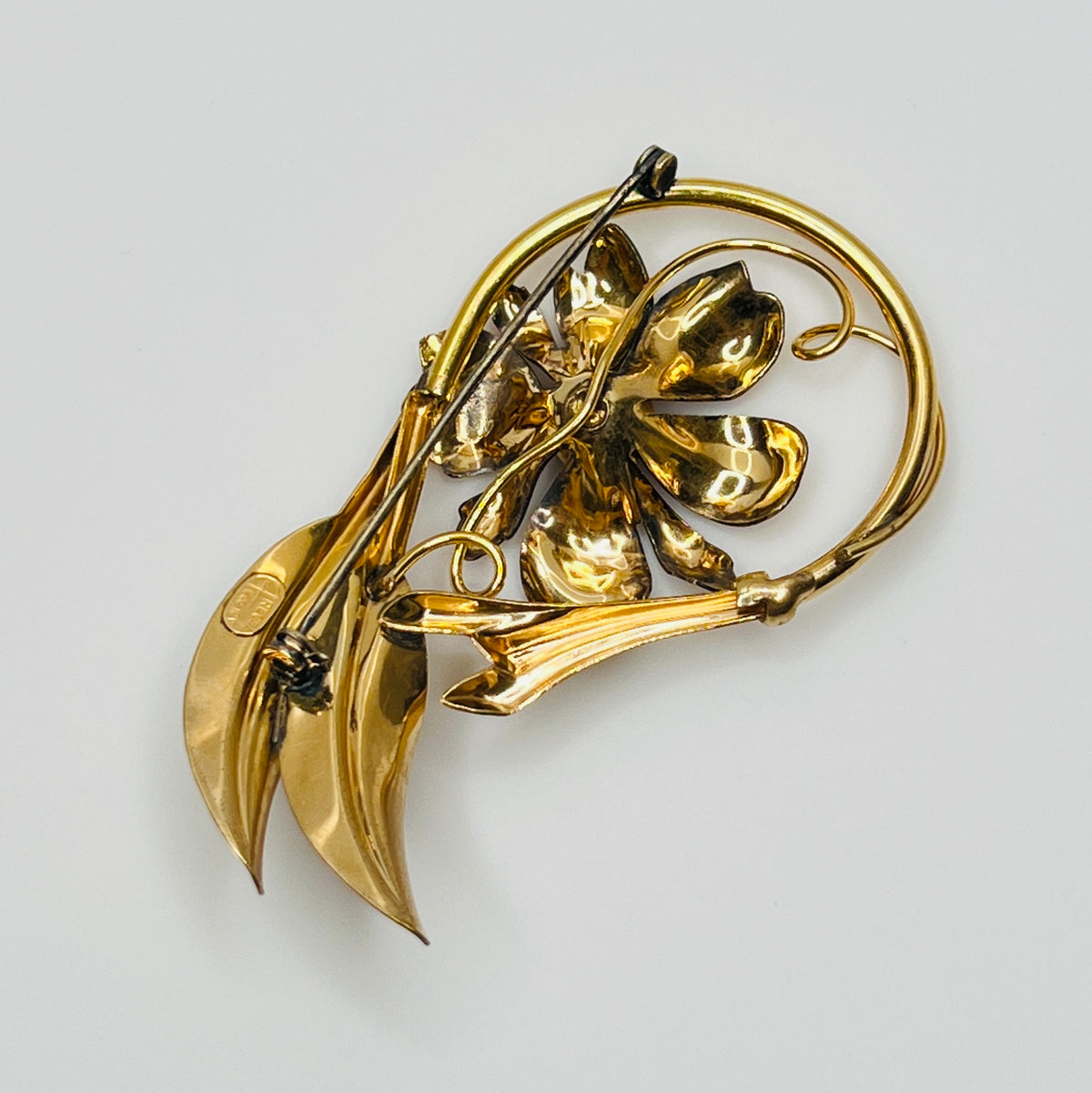 Signed A Regal floral brooch in gold-tone with crystal rhinestone