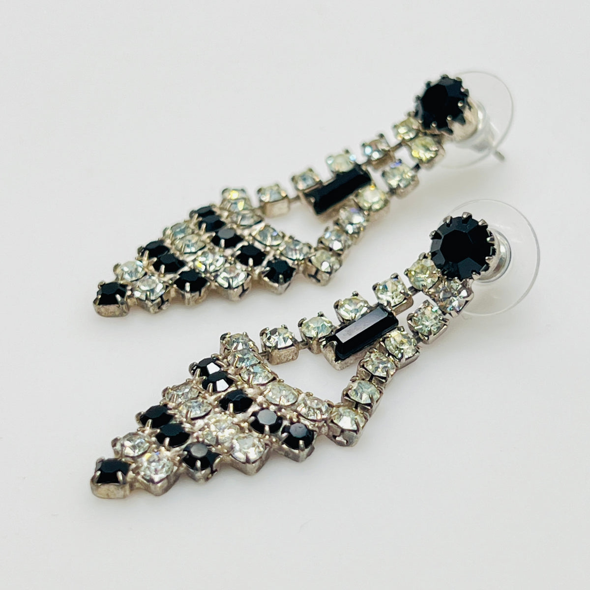 Art Deco-style earrings with black and clear rhinestones in a long silver-tone design