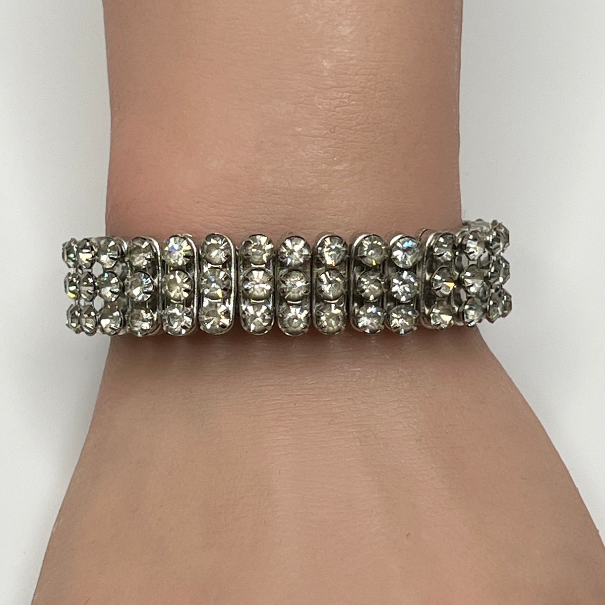 Close-up of vintage silver-tone accordion rhinestone bracelet on wrist