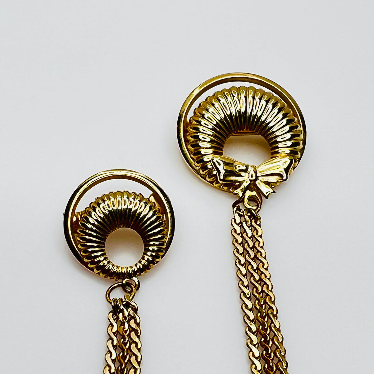 Mid-century gold chatelaine brooch with double wreaths, bow detail, and triple chain drape
