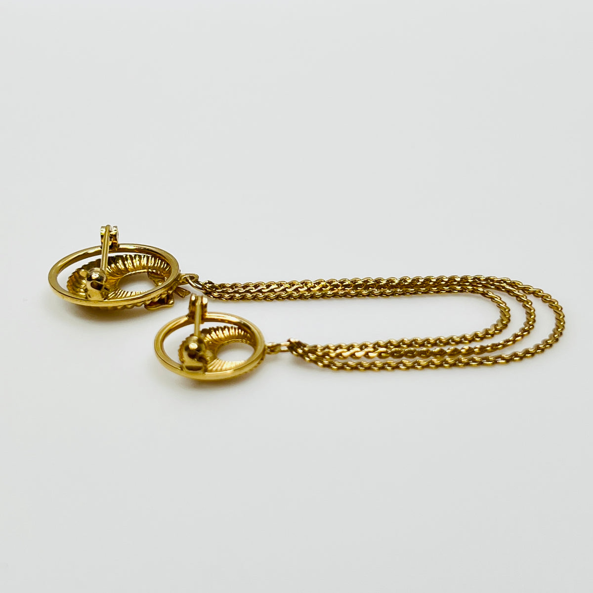 Mid-century gold chatelaine brooch with double wreaths, bow detail, and triple chain drape