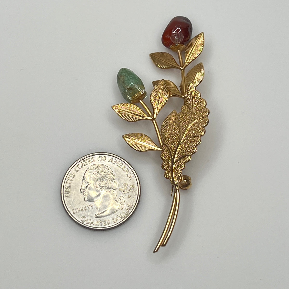 Vintage gold-tone brooch with red and green jade rose buds on long stem