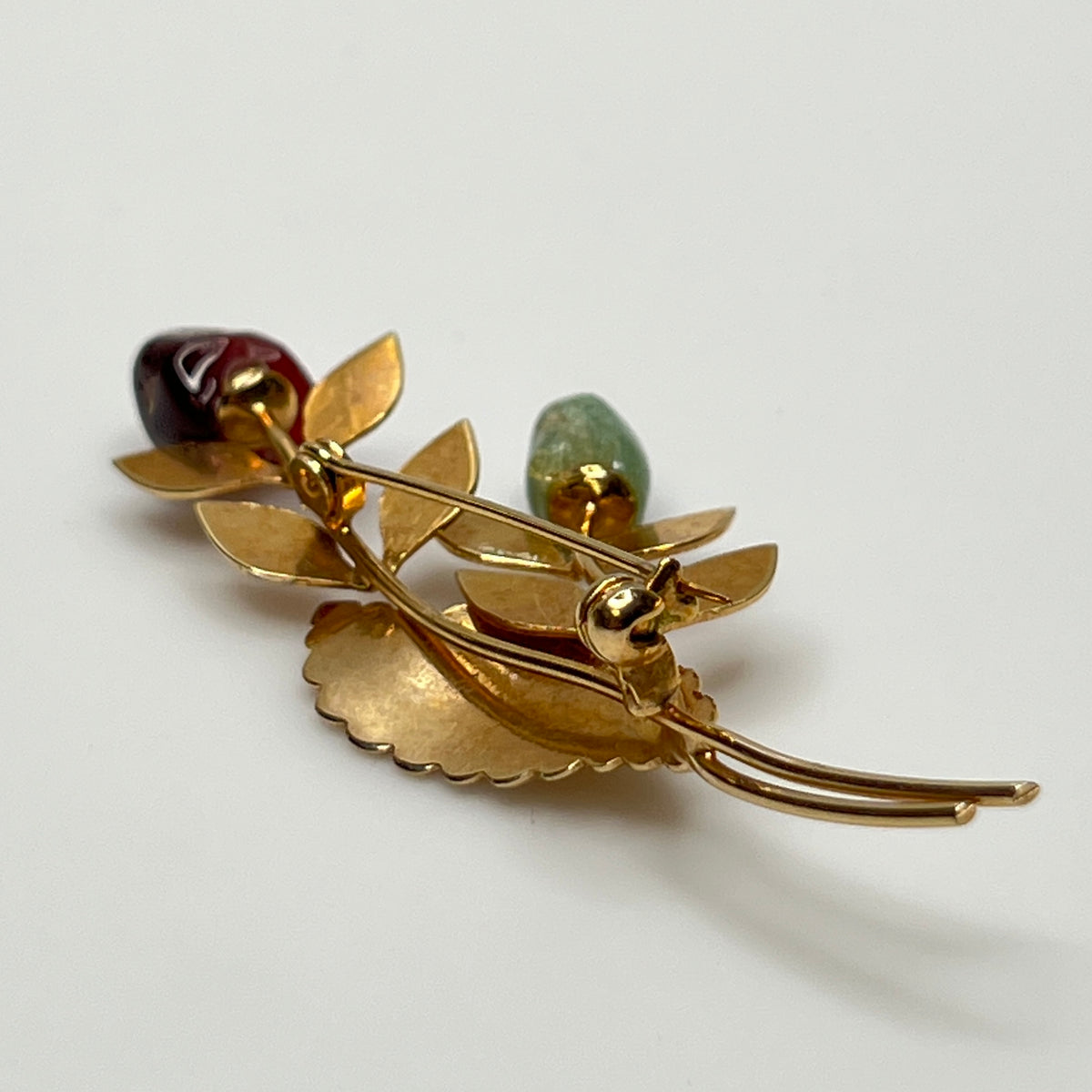 Vintage gold-tone brooch with red and green jade rose buds on long stem