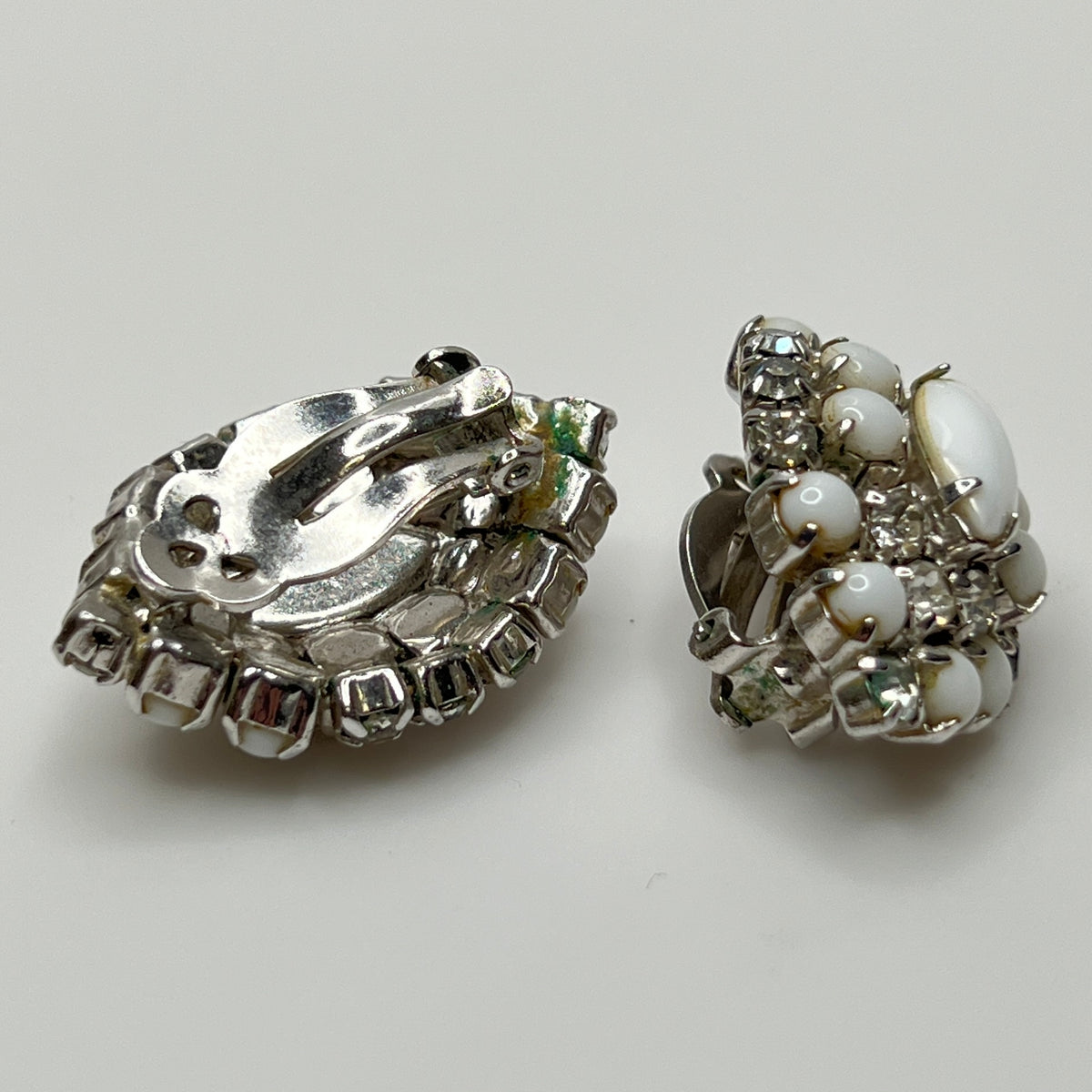 White vintage clip earrings with clear rhinestones and oval centers