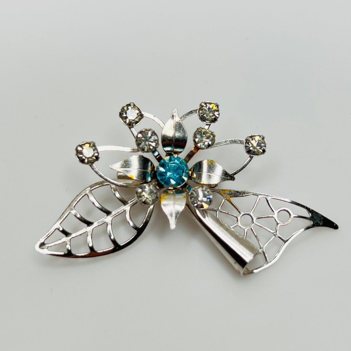 Close-up of brooch with prong-set rhinestones