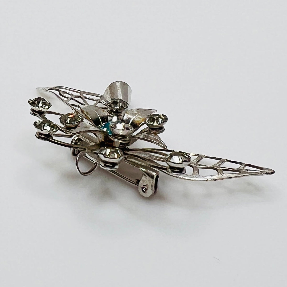 Close-up of brooch with prong-set rhinestones
