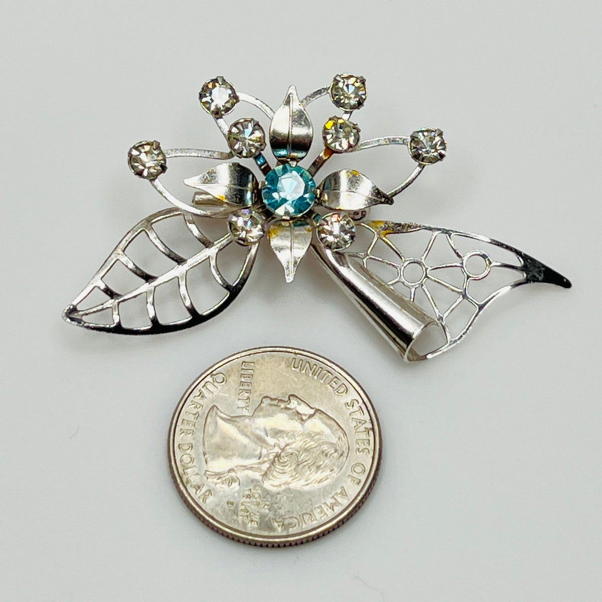 Close-up of brooch with prong-set rhinestones