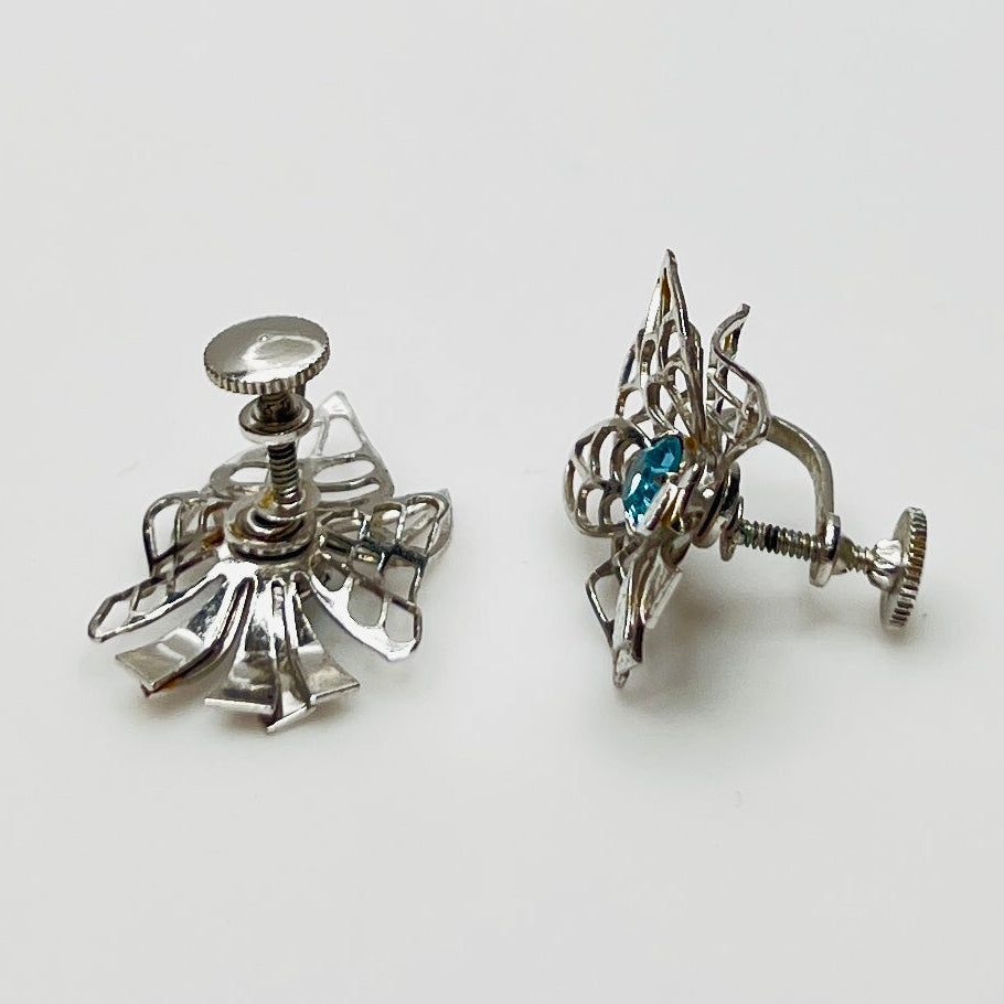 Close-up of filigree earrings with prong-set rhinestones