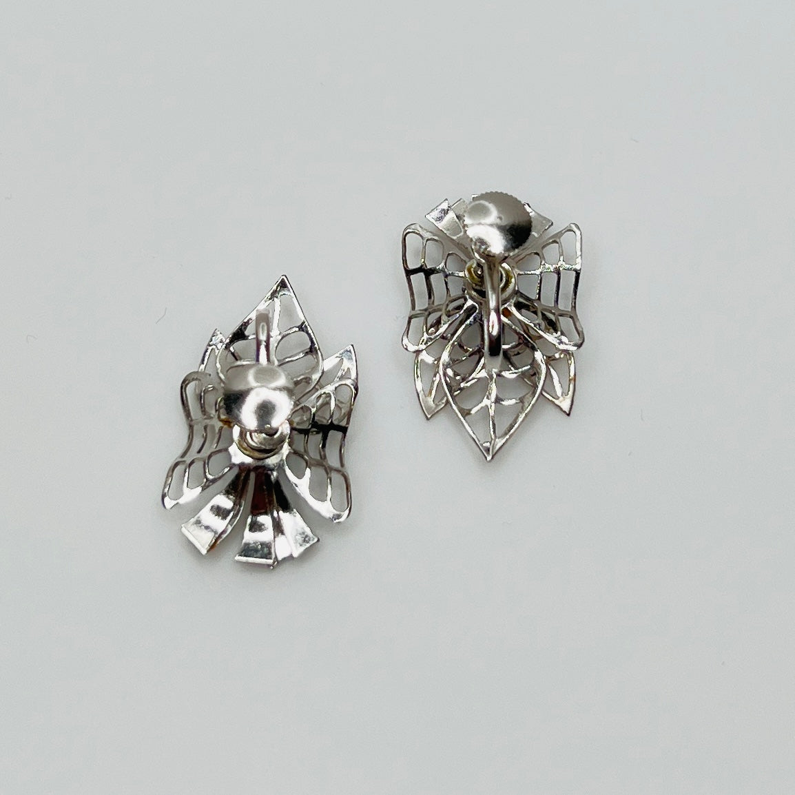 Close-up of filigree earrings with prong-set rhinestones