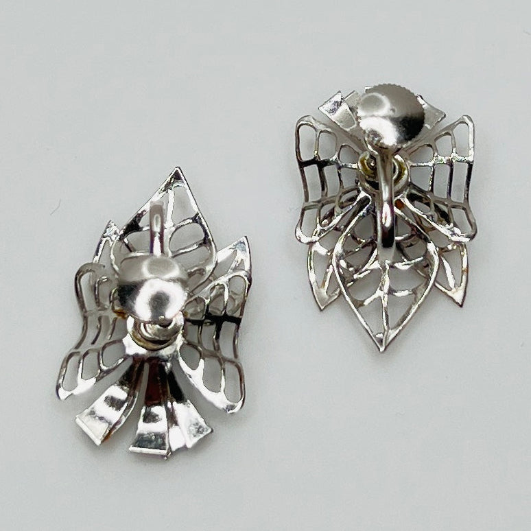 Close-up of filigree earrings with prong-set rhinestones
