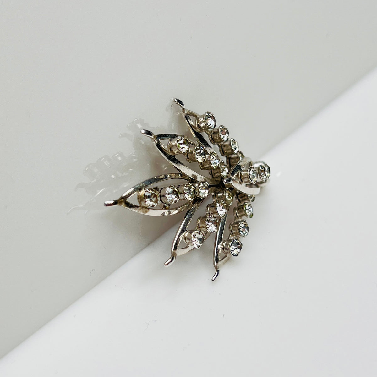 Silver-tone rhinestone leaf brooch with openwork design