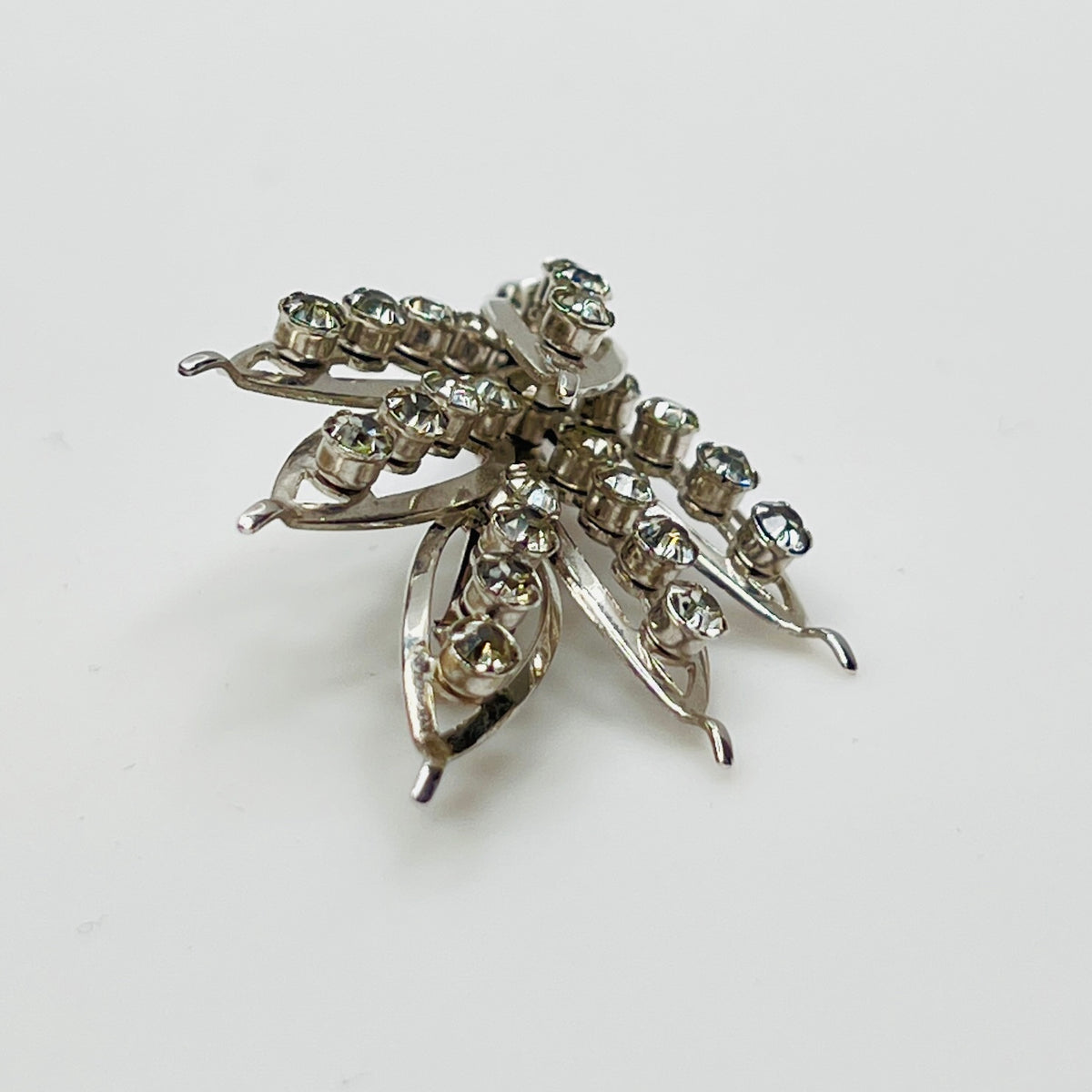 Close-up of vintage rhinestone brooch with prong-set stones