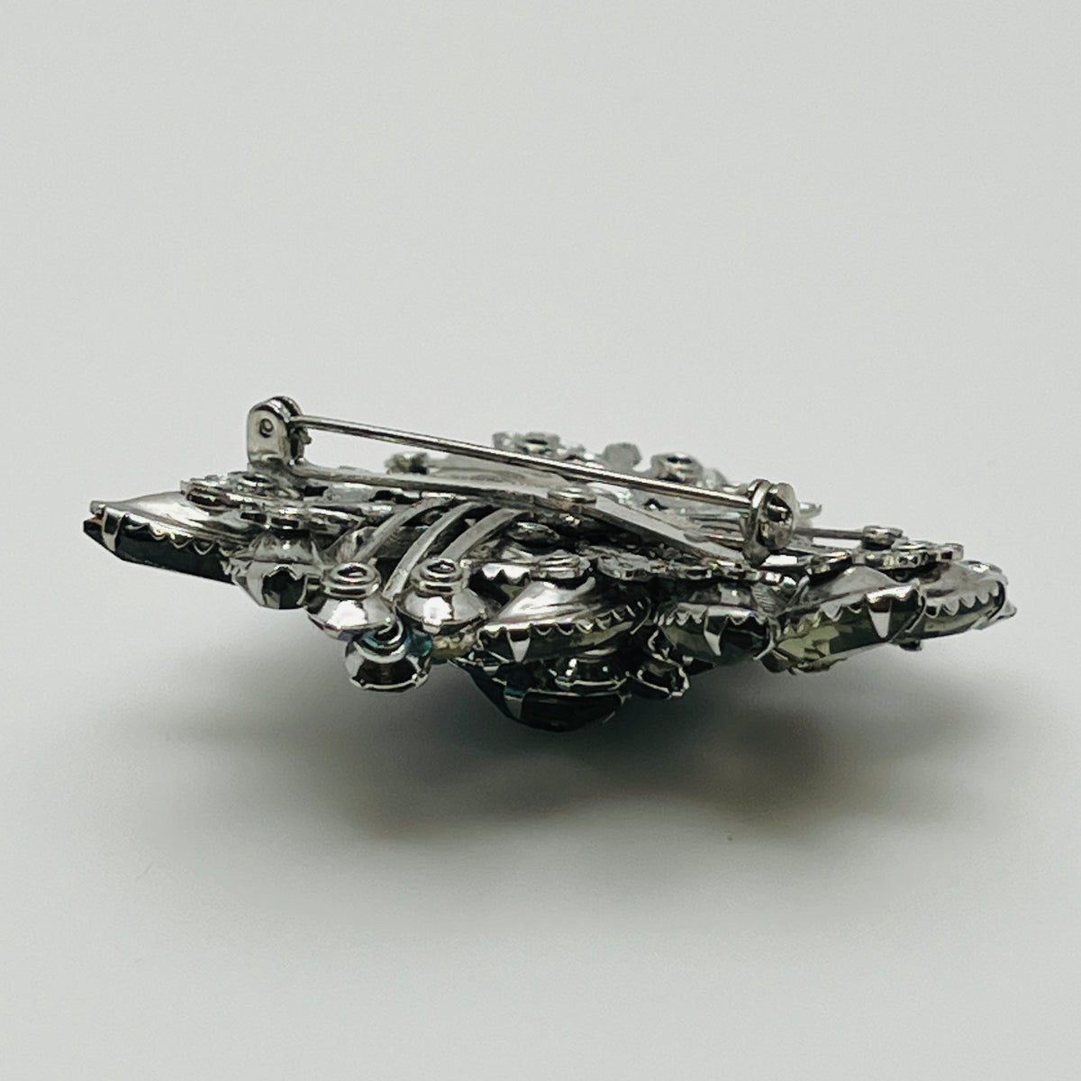 1950s silver-tone rhinestone brooch with leaf and ribbon motif