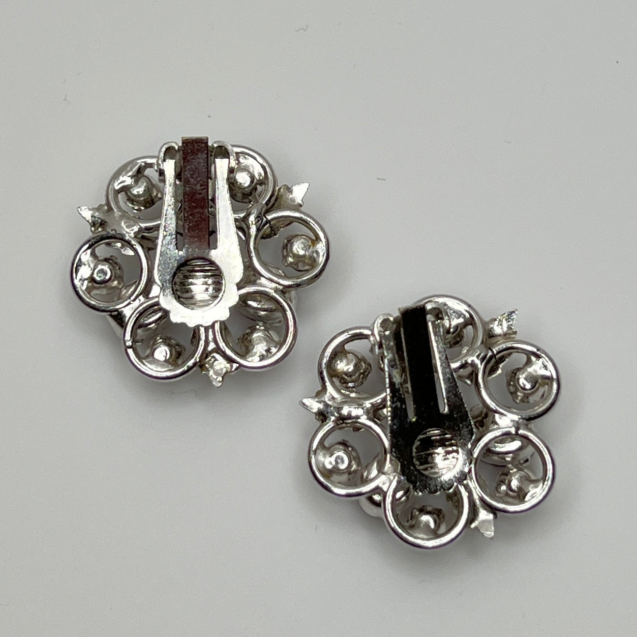 Vintage clip-on earrings with light blue rhinestones and red glass cabochons