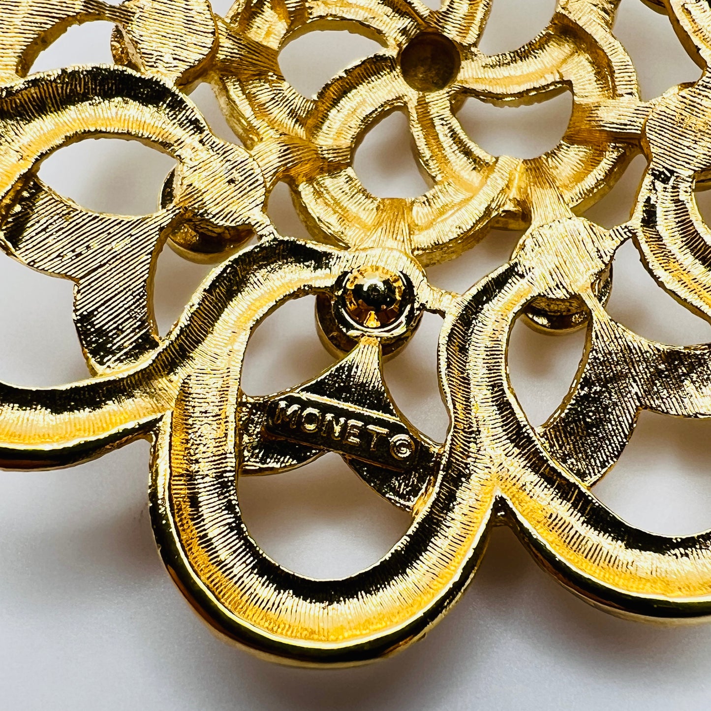 Back of signed Monet mid century gold brooch