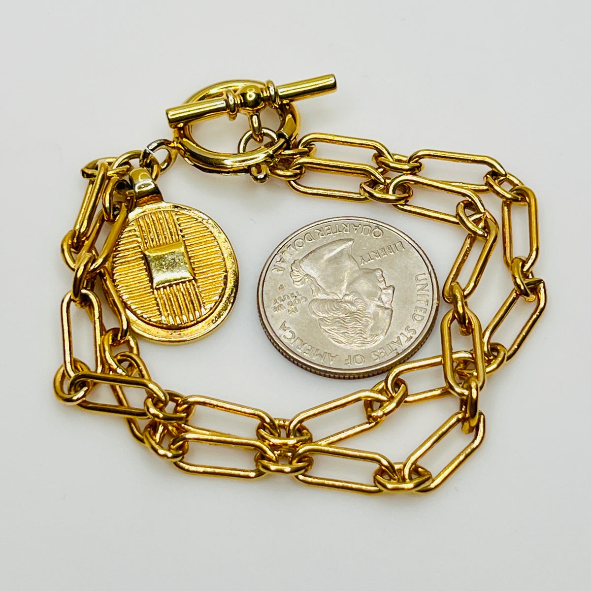 Close-up of round basketweave charm on vintage Ralph Lauren bracelet
