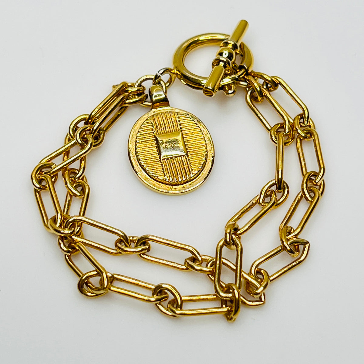 Gold-plated Ralph Lauren charm bracelet with double chain and toggle clasp